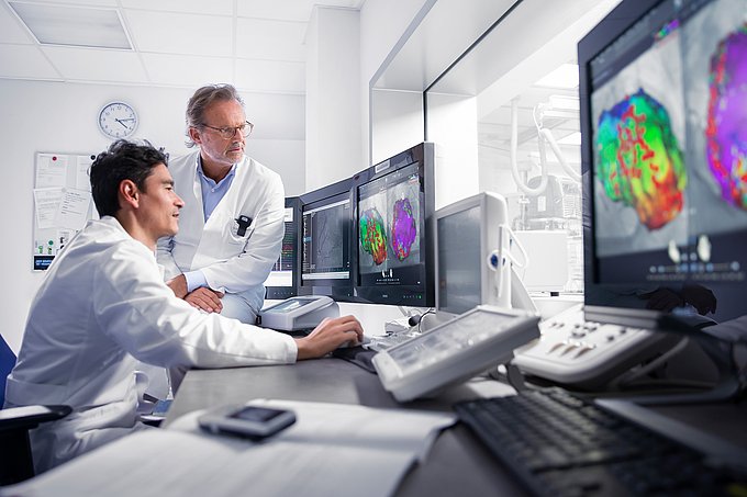 Dies sind zwei Kardiologen bei einer Therapieplanung anhand eines Befunds.