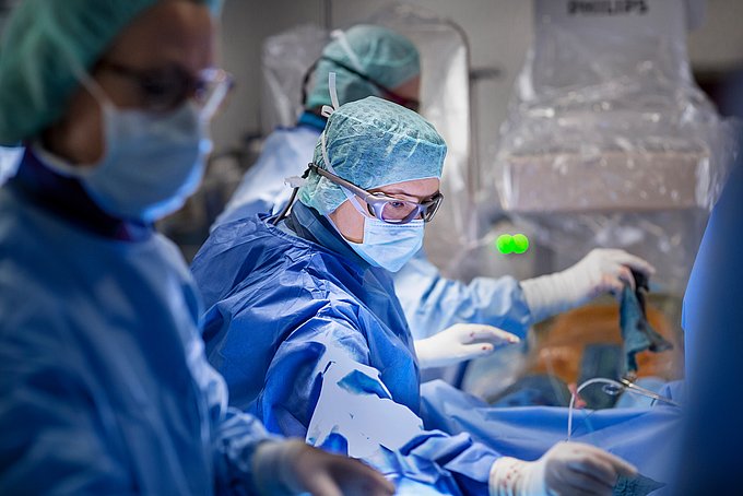 Dies zeigt eine Gefäßchirurgin bei einem minimal-invasiven Eingriff an der Hauptschlagader.